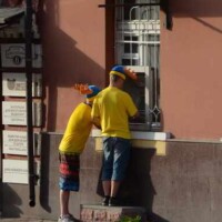 Swedish fans withdraw money from an ATM in Podil, Kyiv