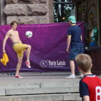 a guy plays with a soccer ball in Kyiv on Independence Square